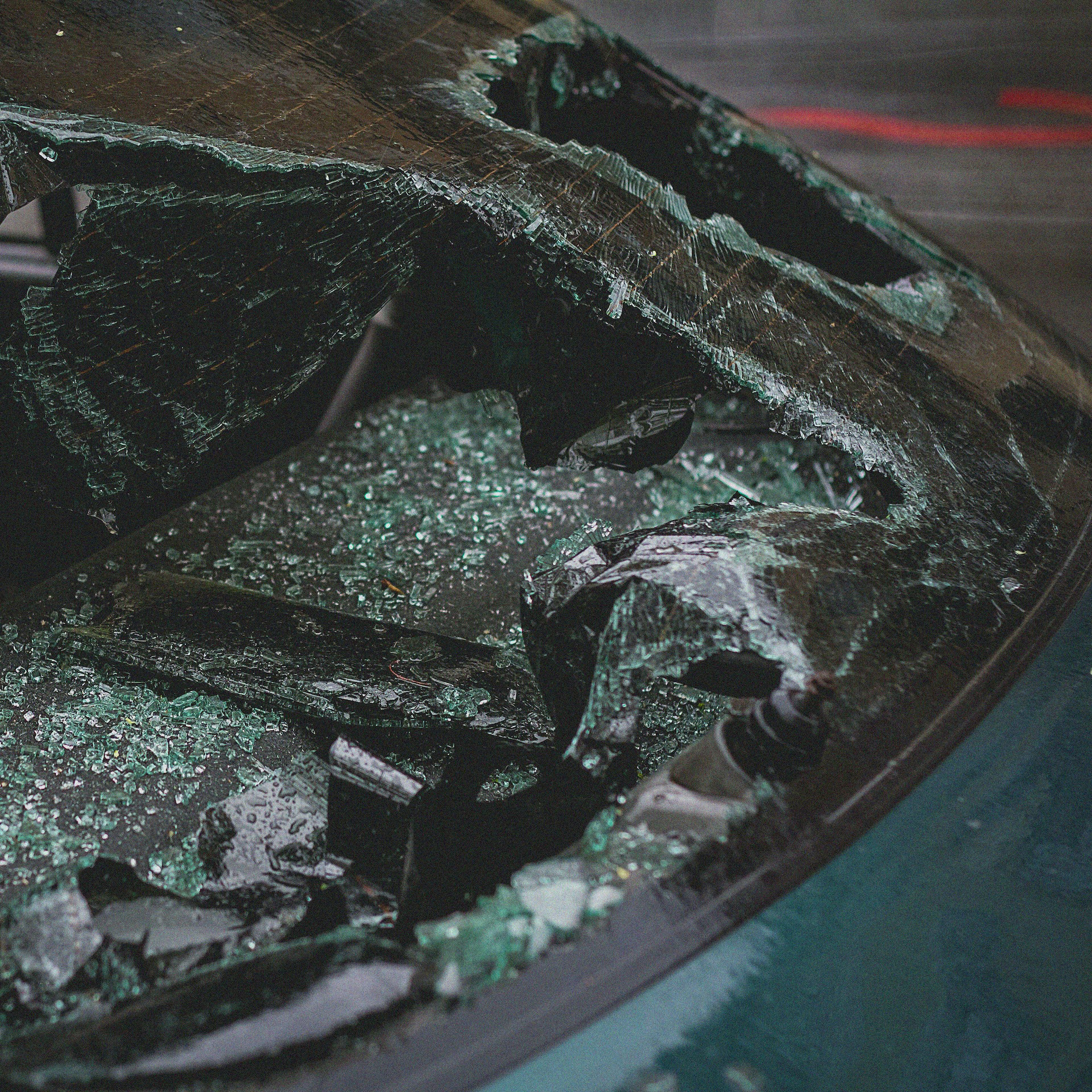 Close-up of a shattered windshield after a car accident, illustrating what to do after a car accident that's not your fault.